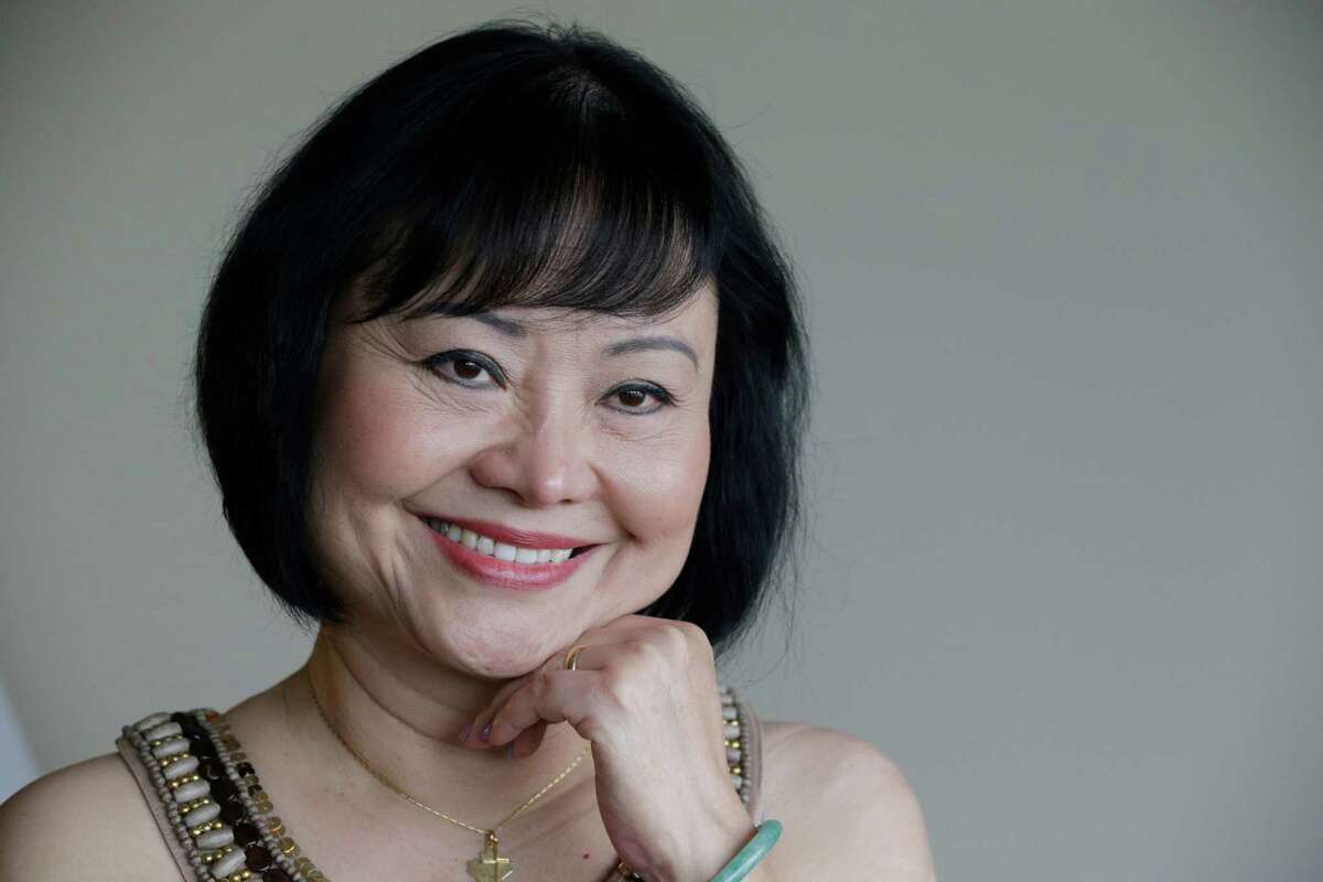 In this Sept. 25, 2015 photo, Kim Phuc poses for a photo at a hotel in Miami. Phuc arrived from her home in Canada to undergo a series of laser treatments to reduce the scars and pain she has endured for 40 years following an attack on her village during the Vietnam war. (AP Photo/Nick Ut)