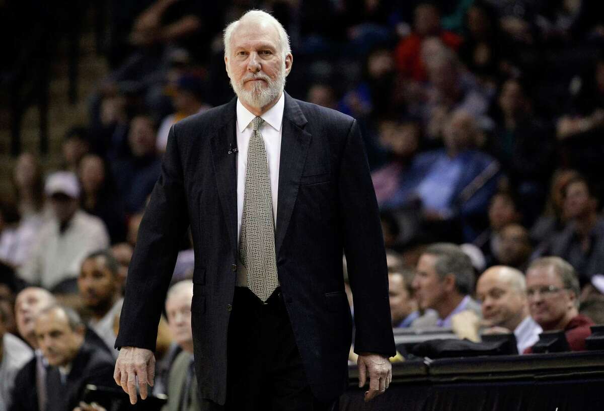 FILE - This is a March 8, 2015, file photo showing San Antonio Spurs head coach Gregg Popovich watching play during the first half of an NBA basketball game against the Chicago Bulls in San Antonio. Popovich, who has led the San Antonio Spurs to five NBA titles, will replace Mike Krzyzewski as the U.S. basketball coach following the 2016 Olympics. (AP Photo/Darren Abate, File)