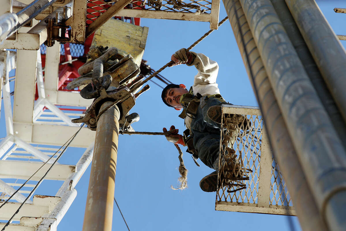 Derrickman Nestor Lerma Jr. guides a drilling pipe on a rig in Atascosa County. He spent most of his life working in oil fields and died in one on May 1.