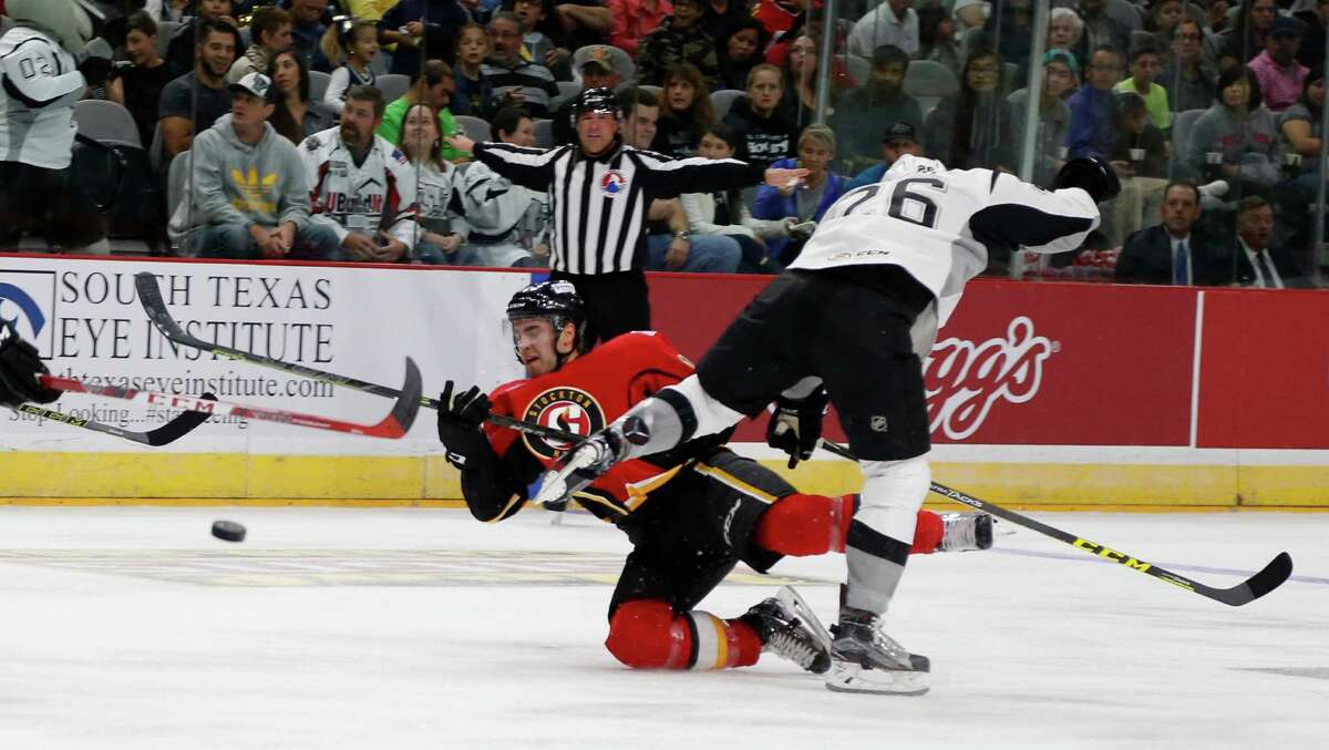 Rampage's Maxim Noreau takes out Stockton's Freddie Hamilton in first period action in American Hockey League home opener for San Antonio on Saturday, October 24, 2015.
