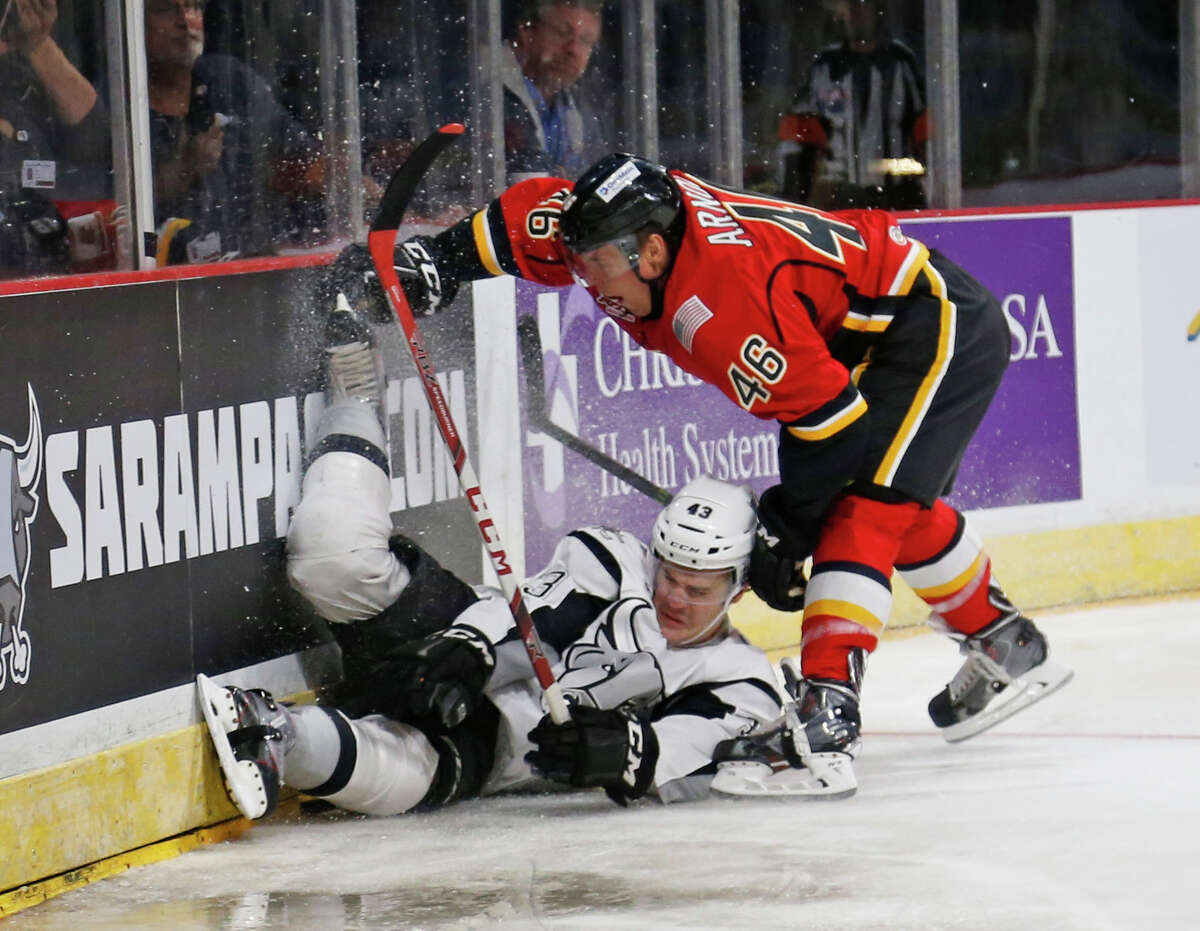 Rampage's Mat Clark battles Stockton's Bill Arnold for possession of the puck in the first period in American Hockey League home opener for San Antonio on Saturday, October 24, 2015.