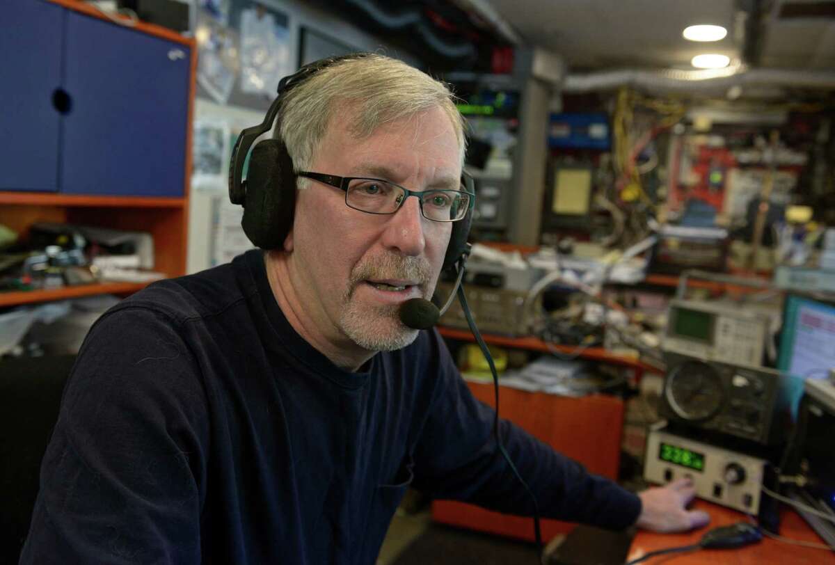 Steve Simons, a ham-radio operator, uses his setup in the basement of his Danbury home on Saturday.