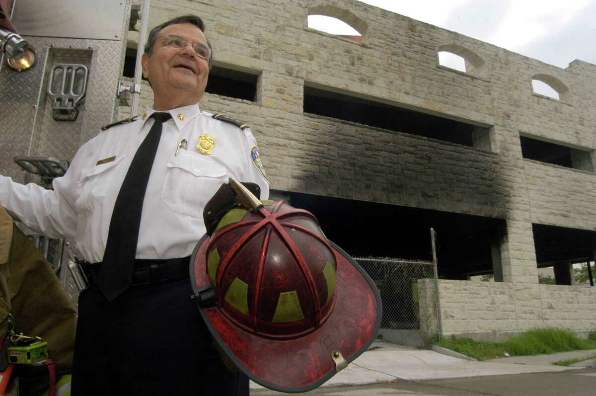 Former fire chief and longtime fire marshal, Eddie Corral, has retired after serving the city of Houston for more than 50 years as the only Hispanic fire chief. Photo taken at the scene of a fire on the corner of Bagby and Washington downtown, Thursday, September 1, 2005.