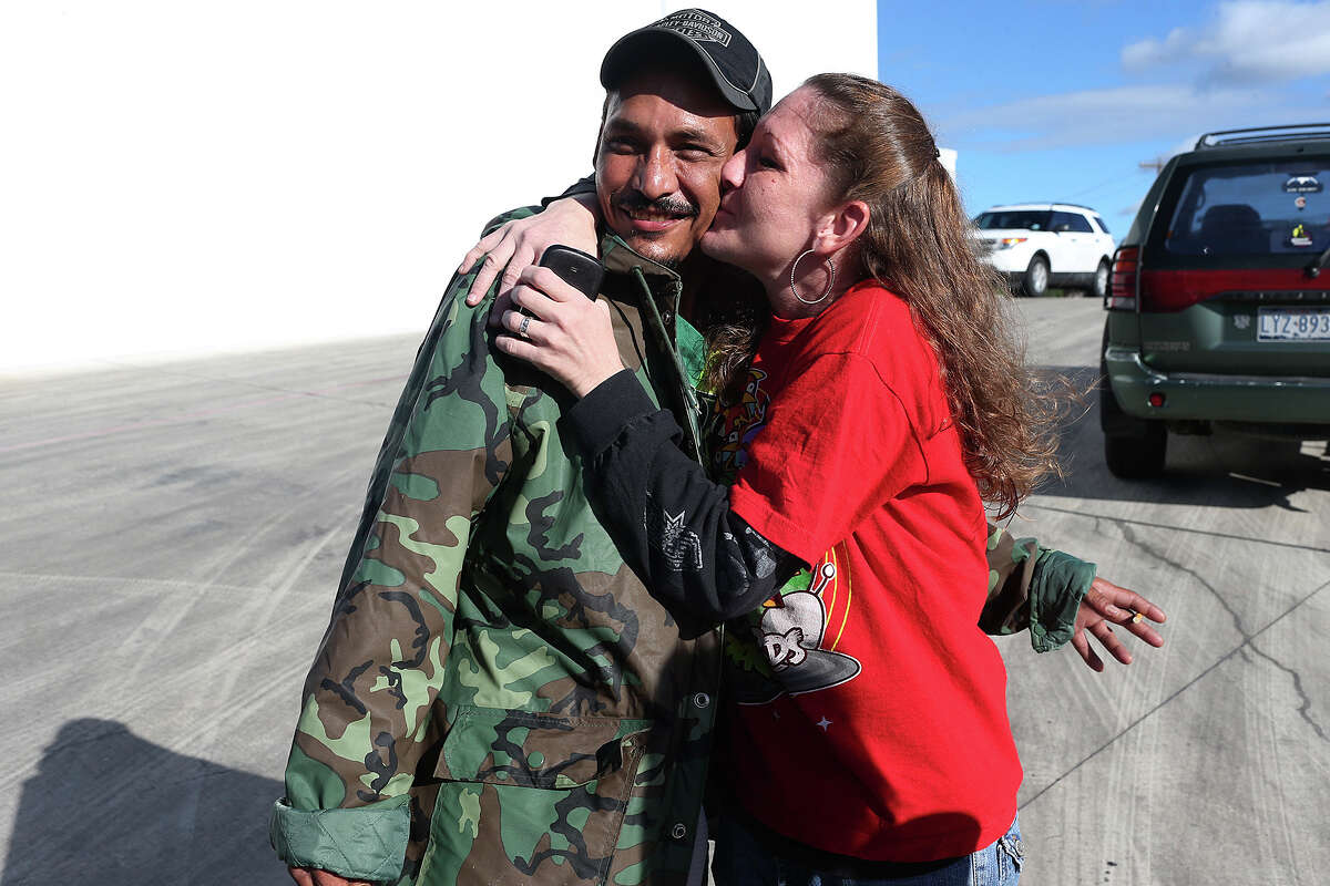 Roel Martinez, 41, gets a kiss from his girlfriend, Angela Crandall, 41, after he survived falling into a drainage culvert full of storm water on Saturday, Oct. 25, 2015. Martinez showed up at a press conference held by the San Antonio Fire Department Chief Charles Hood on Sunday, Oct 25, 2015. Martinez went missing after he attempted to keep his dog, "Chico," from falling into the storm drainage near the intersection of Babcock Road and Fredericksburg in the early hours on Saturday. He was carried by the water through a tunnel and surfaced down stream. His dog also survived.