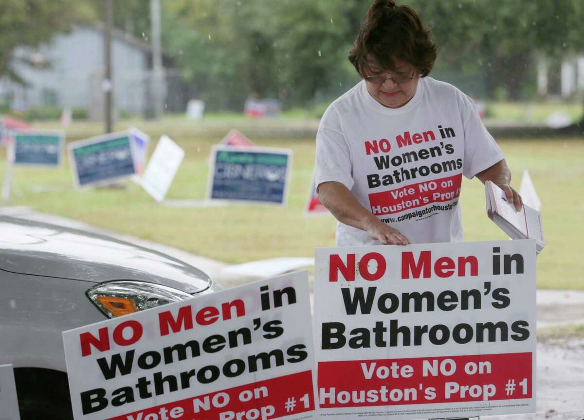Linda "Granny" Rodriguez puts up signs against Proposition 1 at the Moody Community Center Sunday, Oct. 25, 2015, in Houston. "It's rainy, but rain or shine I'm going to be here," she said. ( Jon Shapley / Houston Chronicle )