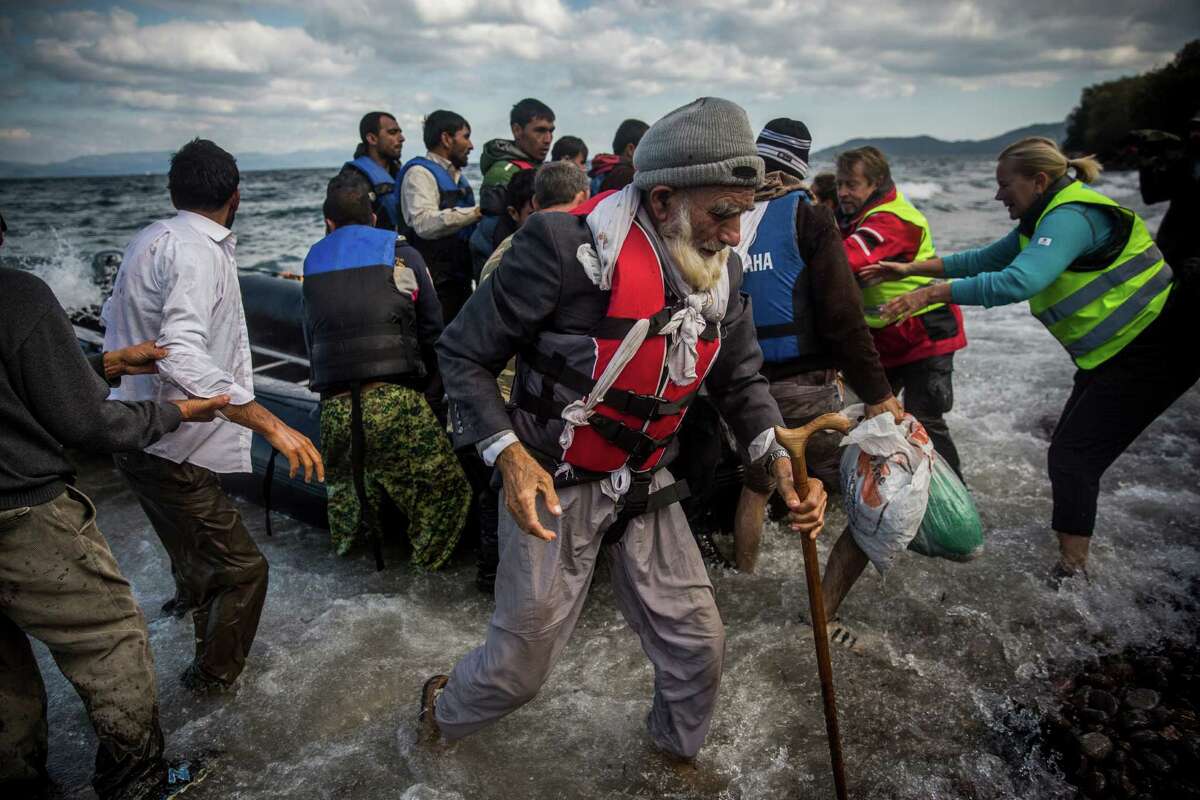 An elderly Afghan disembarks from a dinghy after arriving with other migrants and refugees from a Turkish coast to the northeastern Greek island of Lesbos.