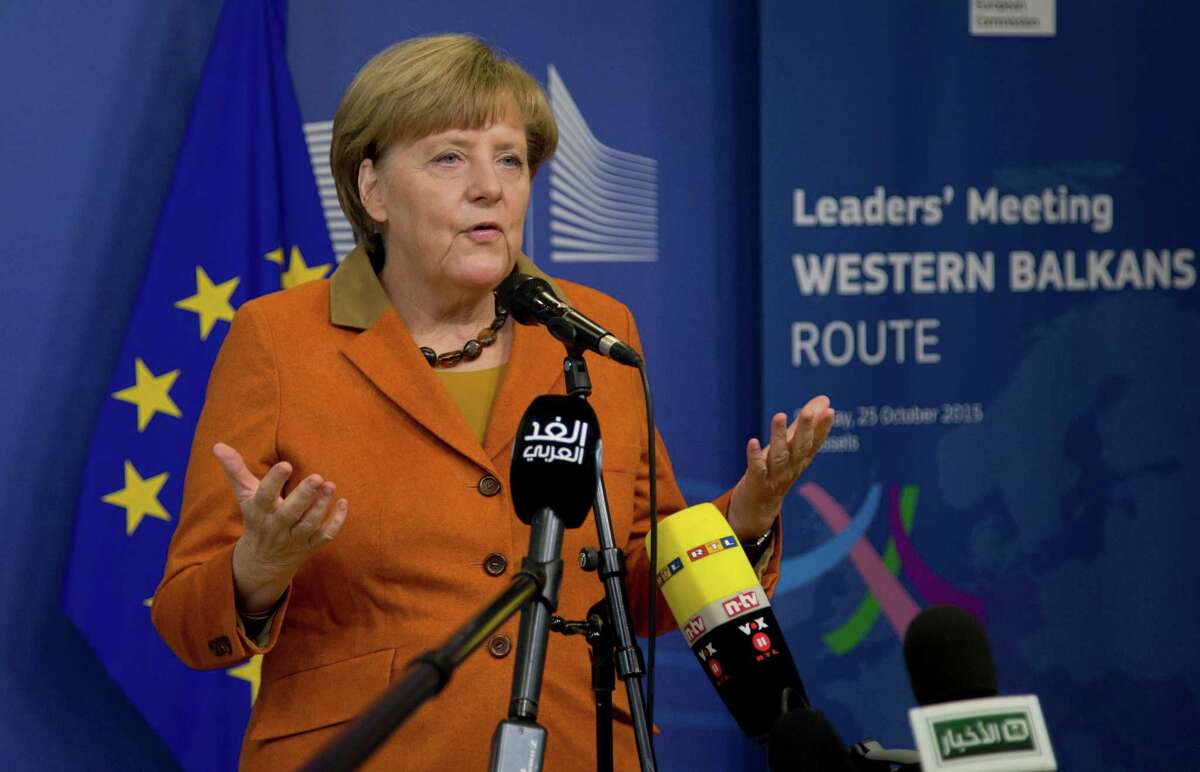 German Chancellor Angela Merkel speaks with the media as she arrives for an EU summit at EU headquarters in Brussels on Sunday, Oct. 25, 2015. EU leaders meet on Sunday to discuss refugee flows along the Western Balkans route. (AP Photo/Virginia Mayo)