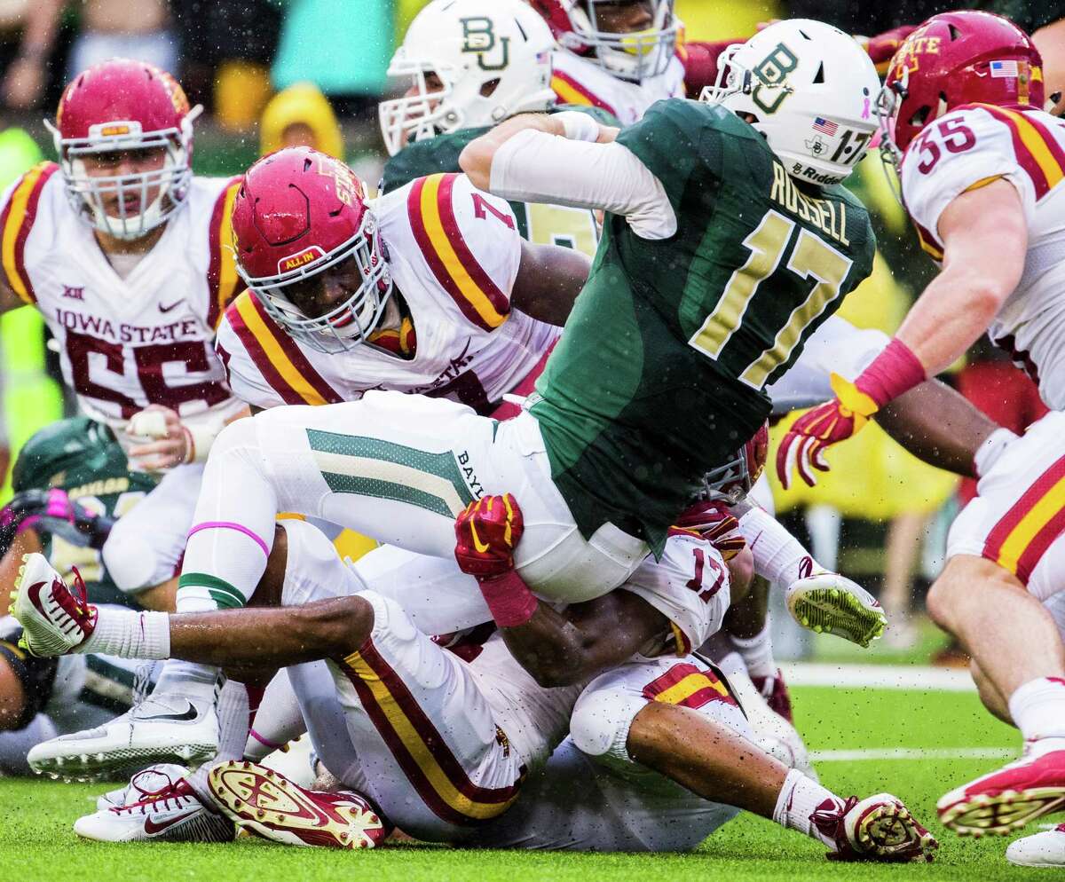 Baylor quarterback Seth Russell (17) is tackled by Iowa State defensive back Jomal Wiltz and others during the first half of an NCAA college football game Saturday, Oct. 24, 2015, in Waco.