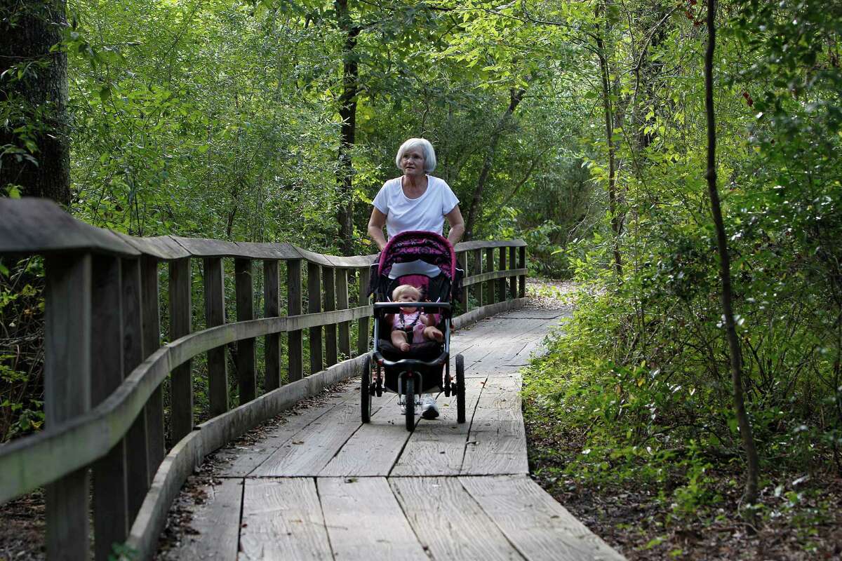Glenna Herron pushes her 9-month-old granddaughter, Ella, along a trail at the Houston Arboretum & Nature Center. ﻿﻿