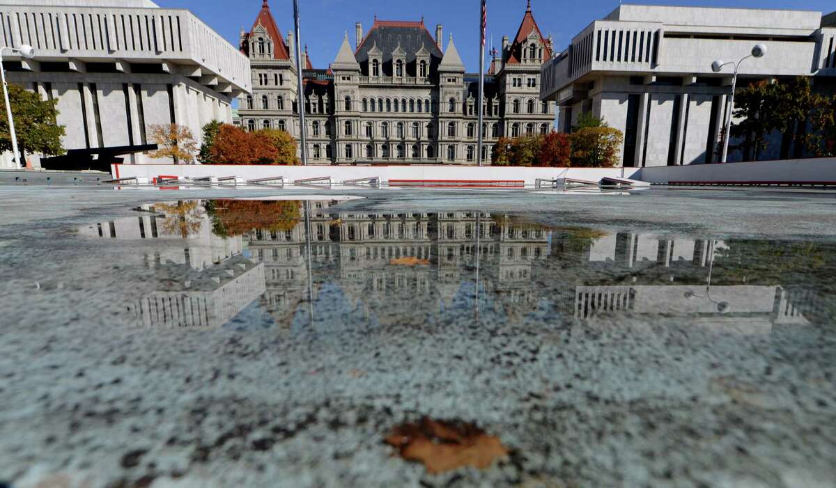 The State Capitol is reflected on the surface of the Empire State Plaza skating rink, which is being assembled for the season Monday, Oct. 26, 2015, in Albany, N.Y. The rink is scheduled to open December 4, weather permitting. (Will Waldron/Times Union)