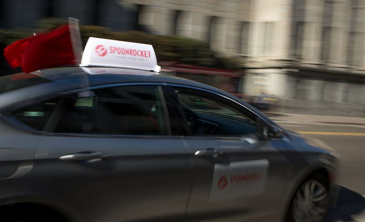 Danetta Davies of SpoonRocket drives away after delivering an order of candy to The San Francisco Chronicle's office on Monday, Oct. 26, 2015 in San Francisco, Calif. SpoonRocket which normally delivers ready-made meals in under 15 minutes is offering a special halloween candy service this week only.