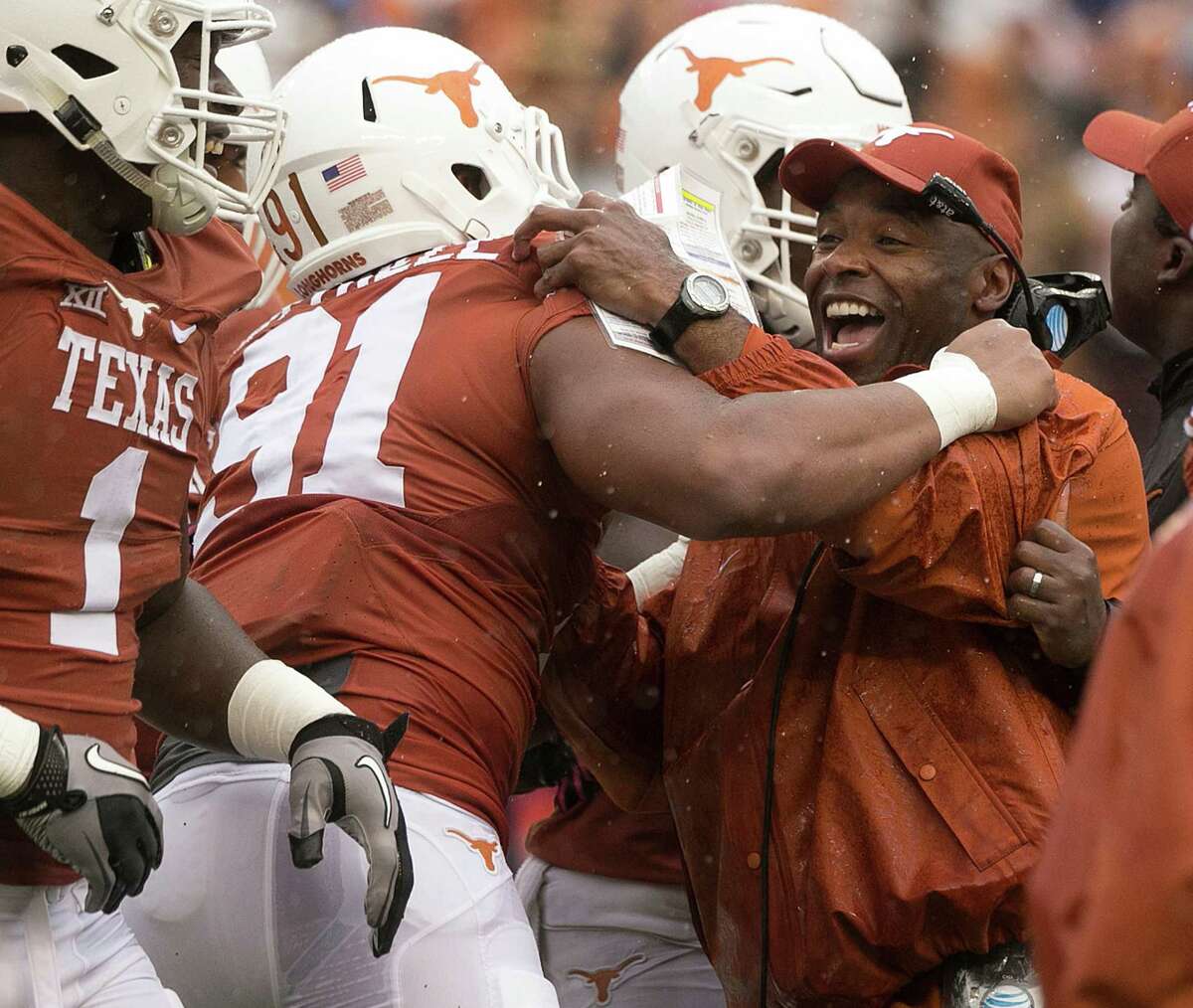 Texas head coach Charlie Strong celebrates with Bryce Cottrell (91) after a sack of Kansas State quarterback in the fourth quarter at Royal Memorial Stadium in Austin, Texas, on Saturday, Oct. 24, 2015. Texas won, 23-9. (Deborah Cannon/American-Statesman/TNS)