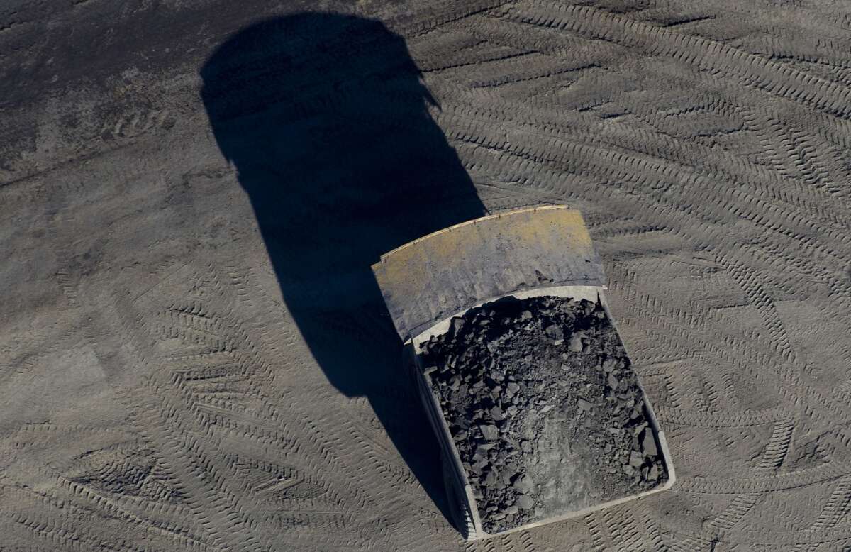A dump truck drives through the Suncor Energy Inc. oil sands mine in this aerial photograph taken near Fort McMurray, Alberta, Canada, on Thursday, June 4, 2015. Photographer: Ben Nelms/Bloomberg