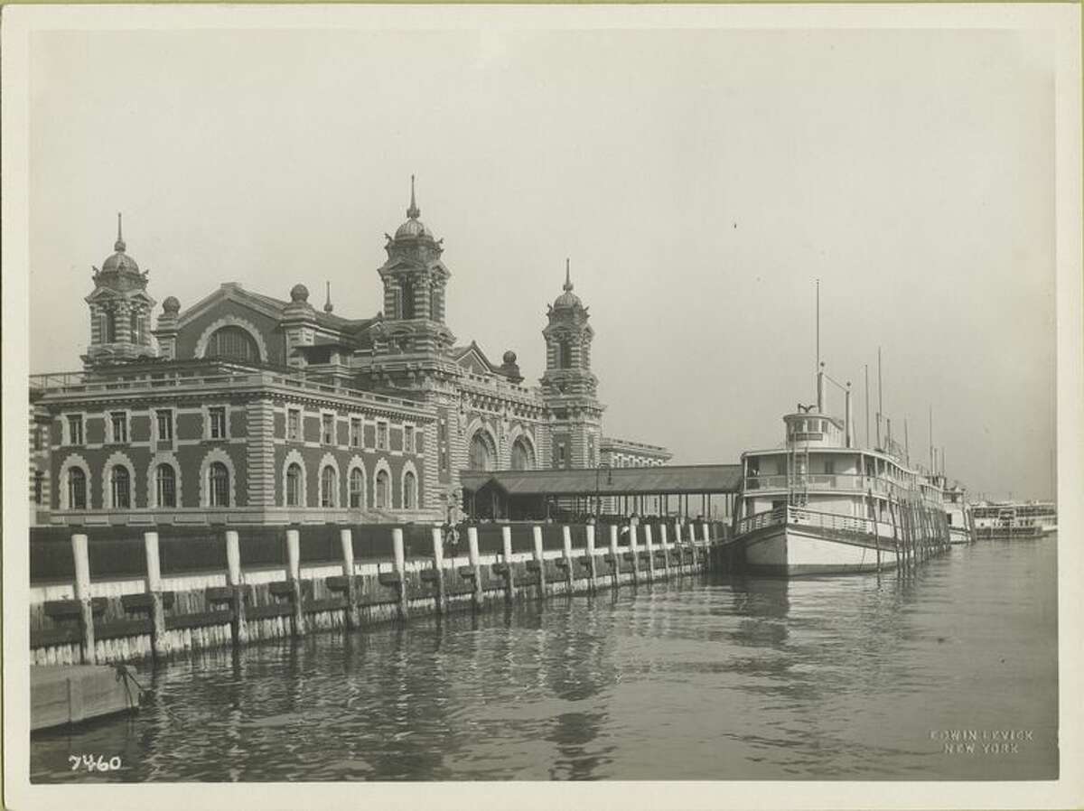 Immigrant Station, Ellis Island, with ferry docked at adjacent pier (1902 - 1913).