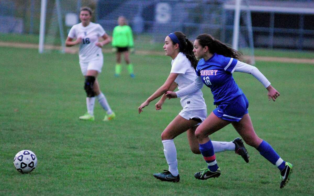 Staples' Tia Zajec, left, battles with Danbury's Taylor Izzo during a girls soccer game in Westport, Connecticut on Tuesday, October 28th 2015.