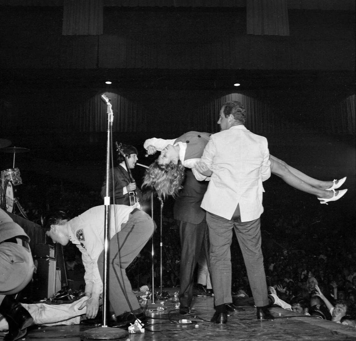 The Beatles are mobbed by fans at the Cow Palace in August 1965.