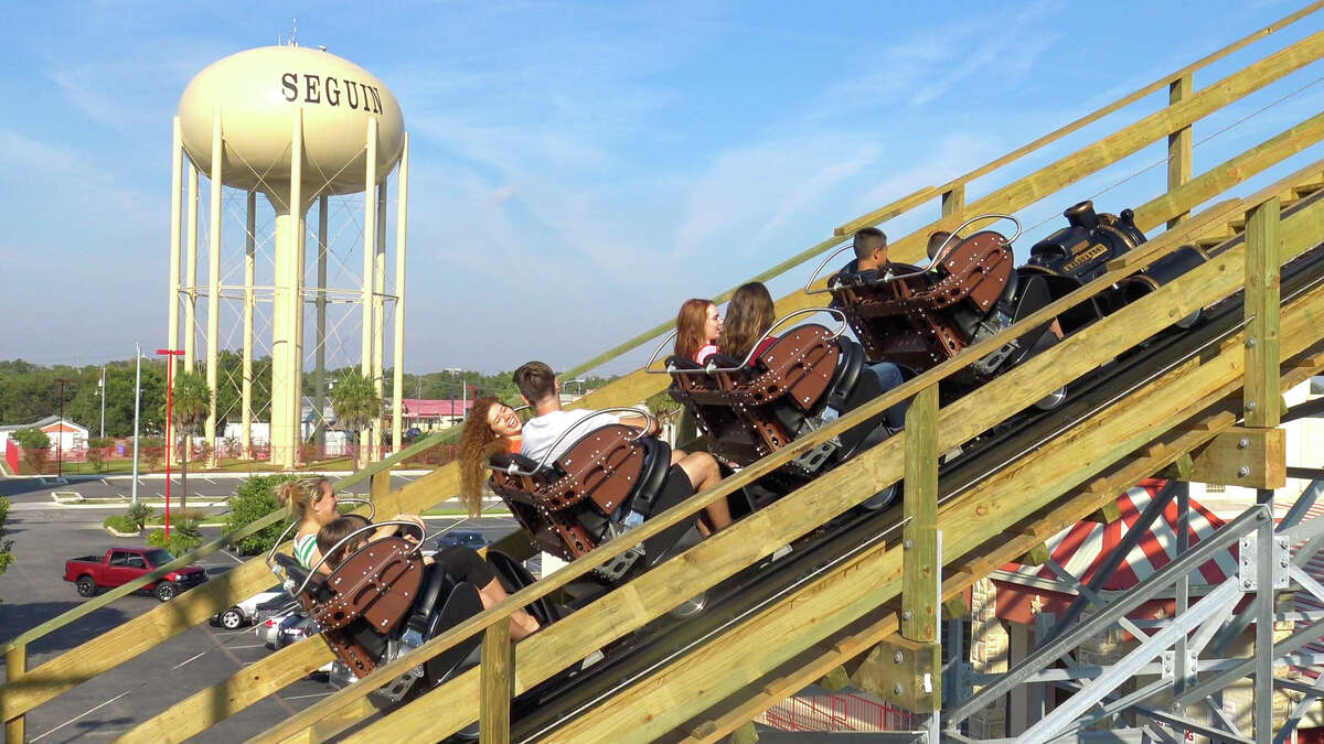 Passengers ride Switchback at ZDT's Amusement Park in Seguin, overlooking the town's water tower.