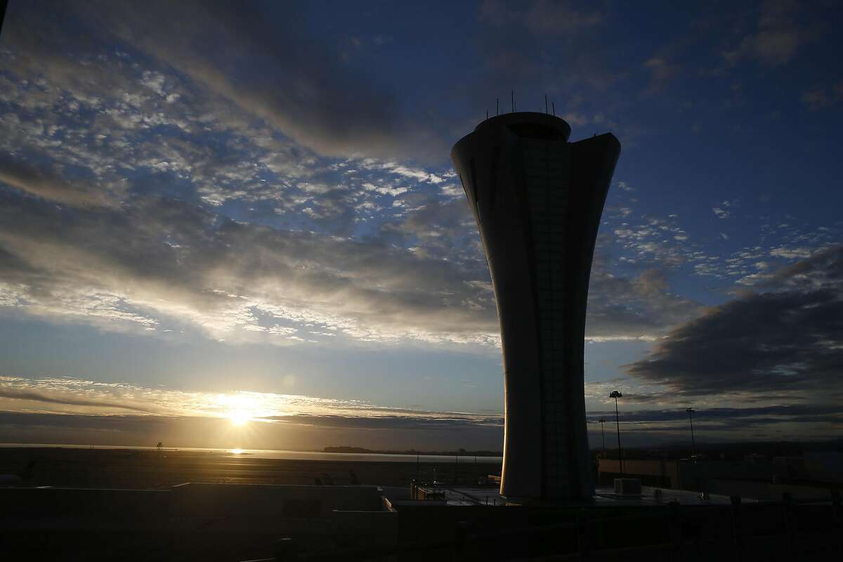 The sun rises behind the new air traffic control tower at SFO in San Francisco, Calif. on Wednesday, Oct. 28, 2015. The state-of-the-art 231-foot tower will replace the older and shorter version when it becomes fully operational in July 2016.