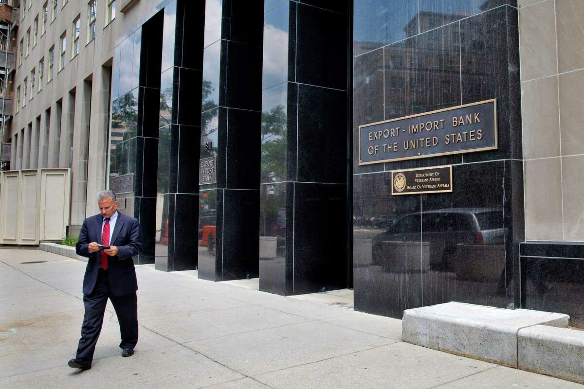 A man walks out of the Export-Import Bank of the United States in Washington. A strong coalition of establishment-backed Republicans and House Democrats voted overwhelmingly Tuesday to revive the Export-Import Bank.