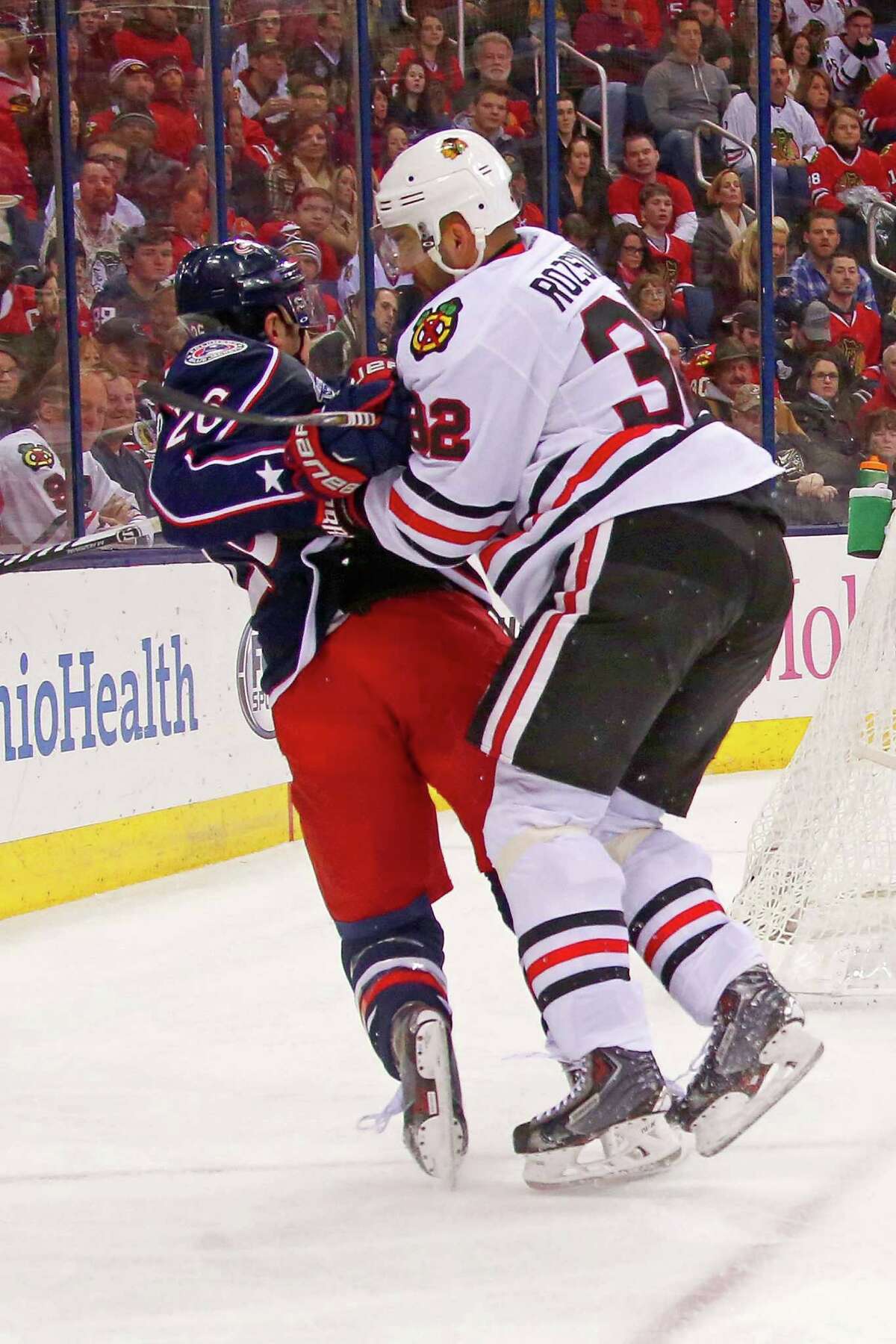 COLUMBUS, OH - DECEMBER 20: Michal Rozsival #32 of the Chicago Blackhawks checks Corey Tropp #26 of the Columbus Blue Jackets during the second period on December 20, 2014 at Nationwide Arena in Columbus, Ohio. (Photo by Kirk Irwin/Getty Images) ORG XMIT: 507048377
