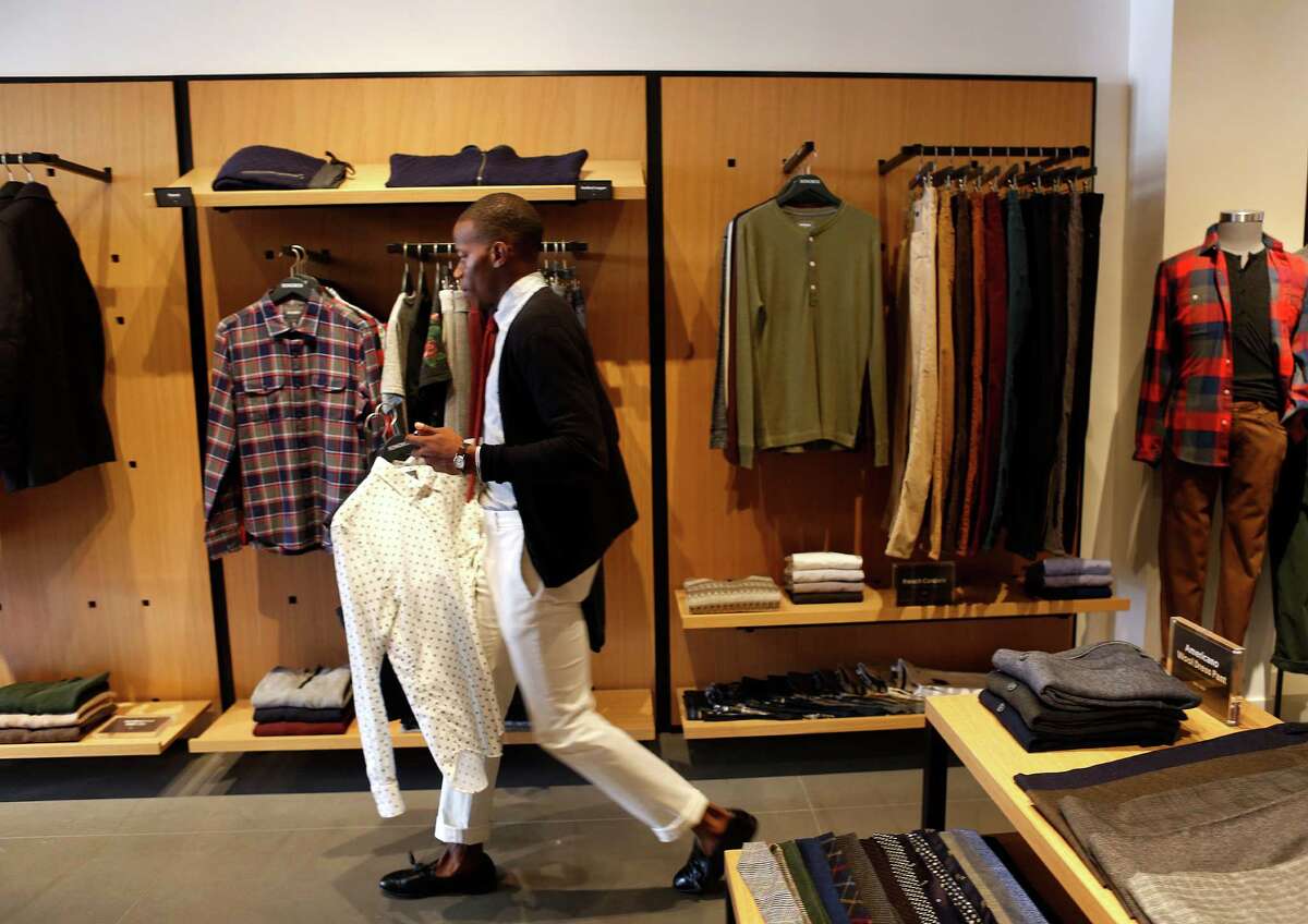 David Rochez, who writes a men's fashion blog, tries on clothes at the new Bonobos Guideshop in River Oaks, Wednesday, Oct. 28, 2015, in Houston. The Guideshop allows men to come into the store, try clothes on, and then order the clothes online to be delivered to their door.
