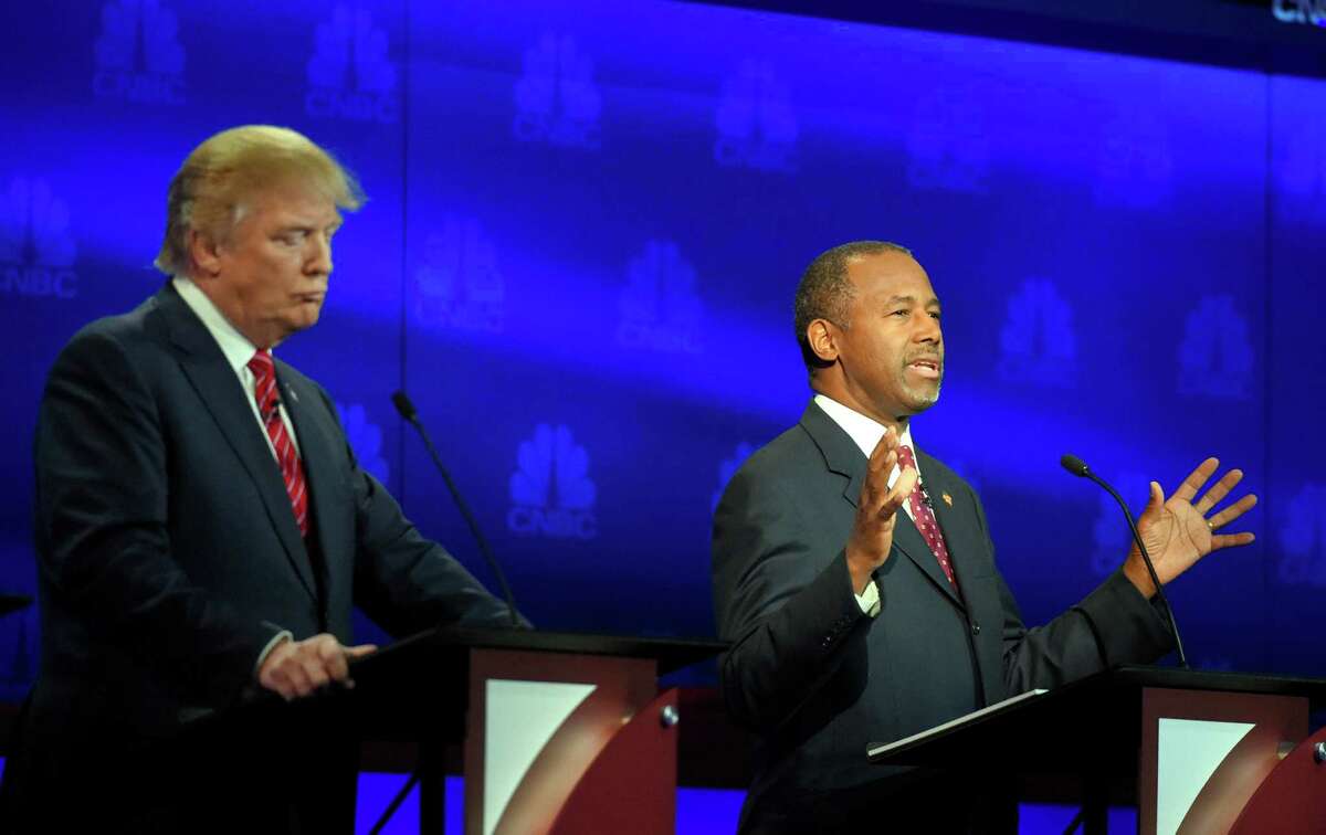 Ben Carson, right, makes a point as Donald Trump looks on during the CNBC Republican presidential debate at the University of Colorado, Wednesday, Oct. 28, 2015, in Boulder, Colo. (AP Photo/Mark J. Terrill)