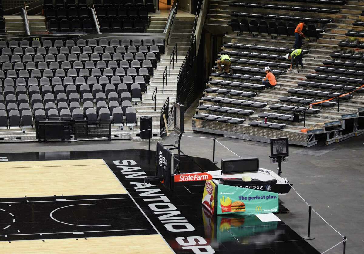 Workers on Wednesday, Oct. 28, 2015, help prepare the AT&T Center to host the San Antonio Spurs' home opener.