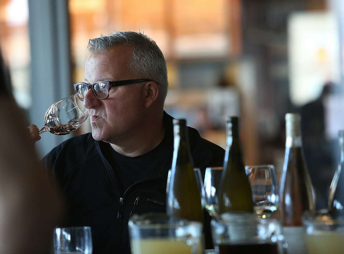 Winemaker Abe Schoener samples at the bar after wine director at The Slanted Door shows her chosen wines (right) in San Francisco, Calif., on Wednesday, October 28, 2015.