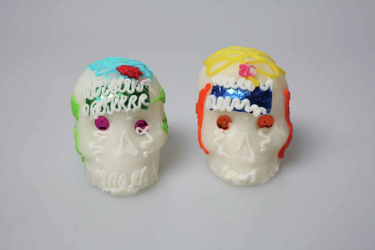 A pair of calaveras, or sugar skulls, are traditional decorations for Día de los Muertos.