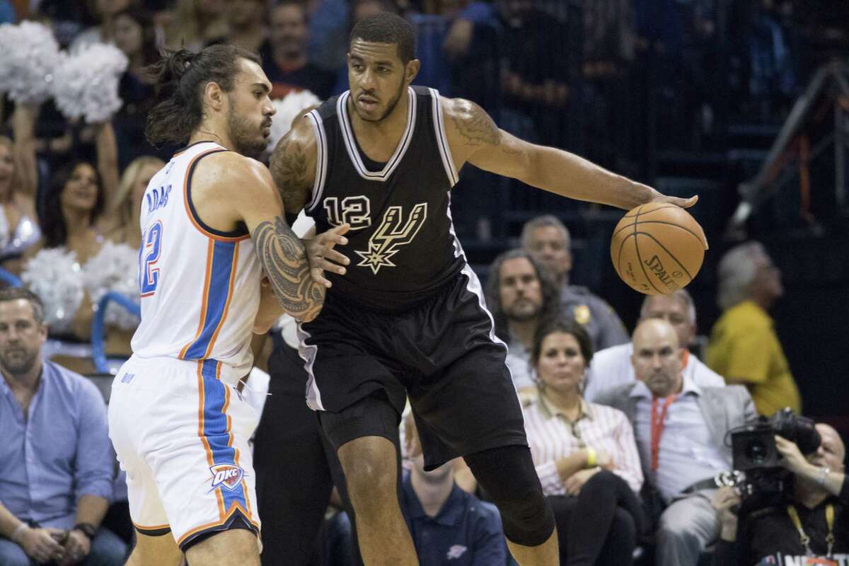 LaMarcus Aldridge of the San Antonio Spurs posts up against Steven Adams of the Oklahoma City Thunder during the first quarter on Oct. 28, 2015 in Oklahoma City.