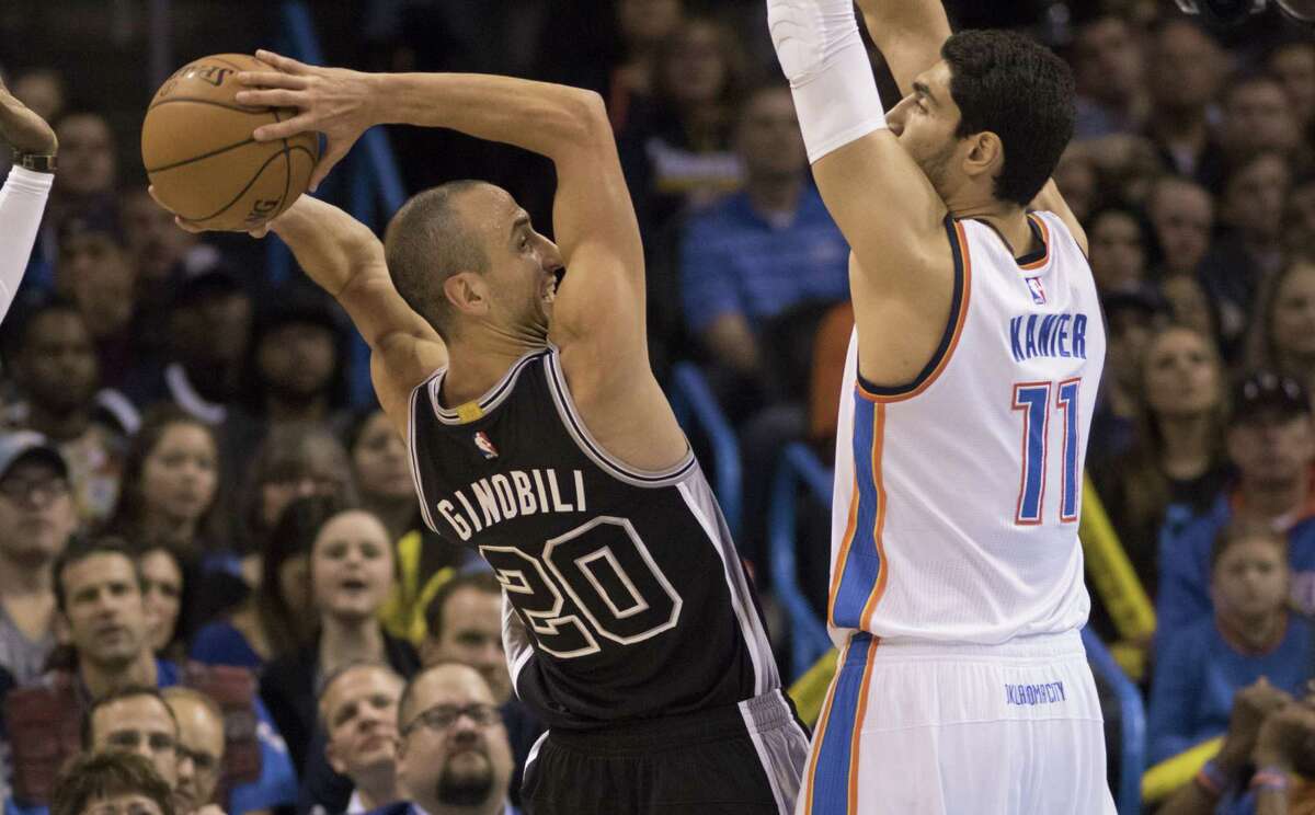 Enes Kanter of the Oklahoma City Thunder guards Manu Ginobili o the San Spurs, forcing him to pass during the first quarter on Oct. 28, 2015.
