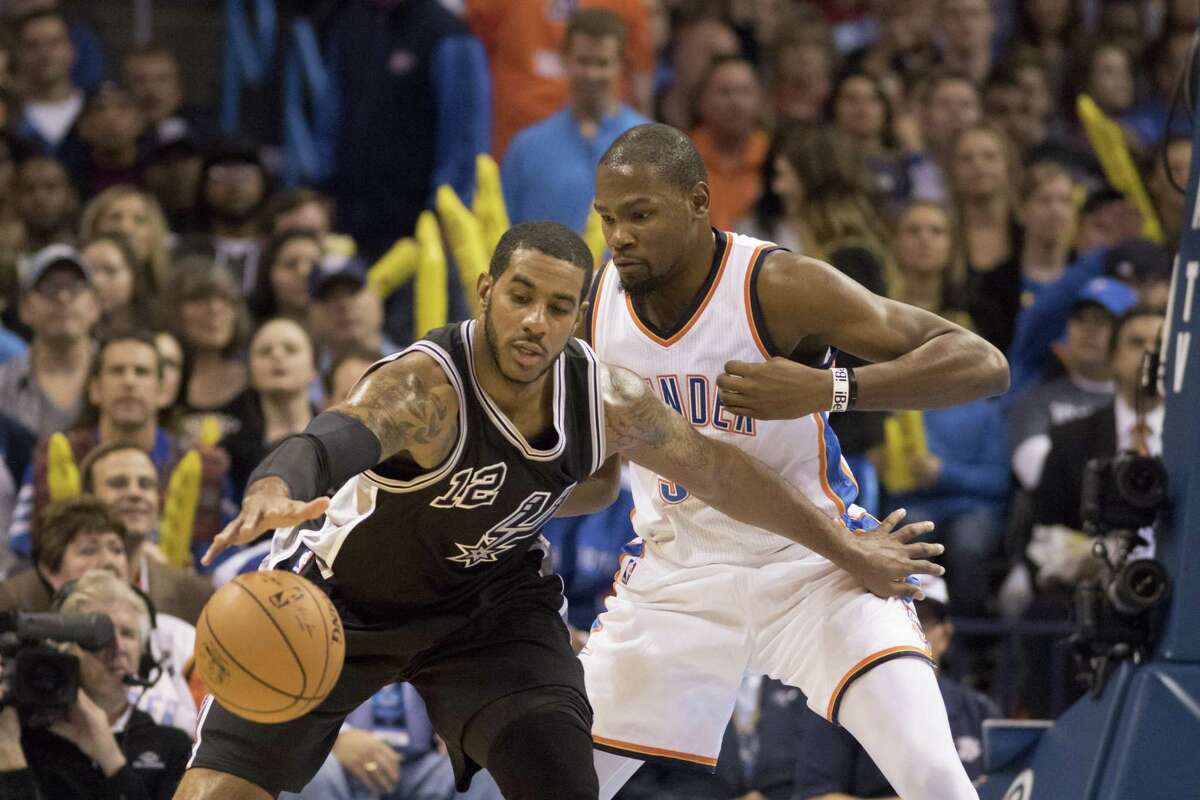 LaMarcus Aldridge of the San Antonio Spurs is defended by Kevin Durant of the Oklahoma City Thunder during the first quarter on Oct. 28, 2015 in Oklahoma City.