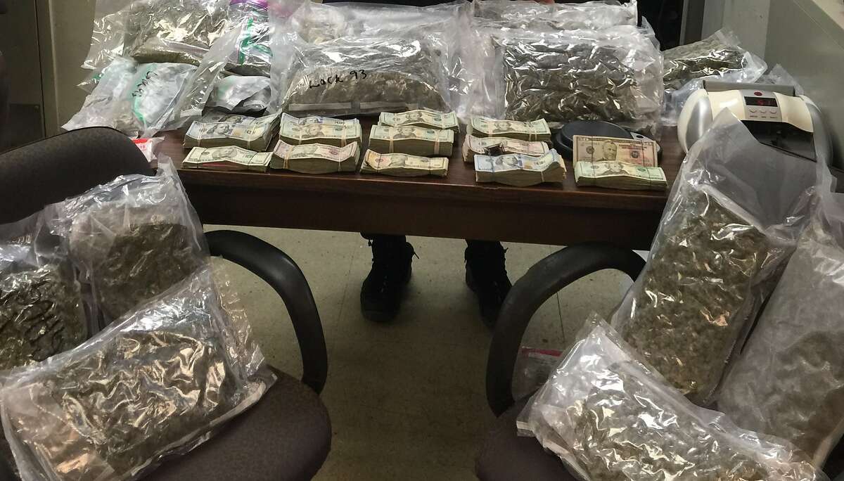 Packaged marijuana and cash sits on a table in New York after the arrest of three men on drug-related charges on Wednesday, Oct. 27, 2015. One of the men is a dentist from San Francisco who marketed his dentistry practice as marijuana-user-friendly.