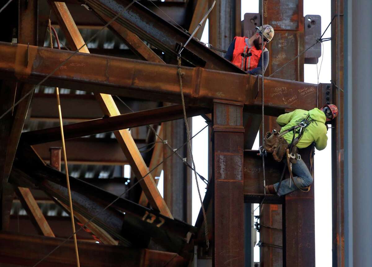 Iron workers help to build the new Comcast Innovation and Technology Center in Philadelphia. Third-quarter growth of represents a marked drop from the 3.9 percent pace of expansion in the spring.
