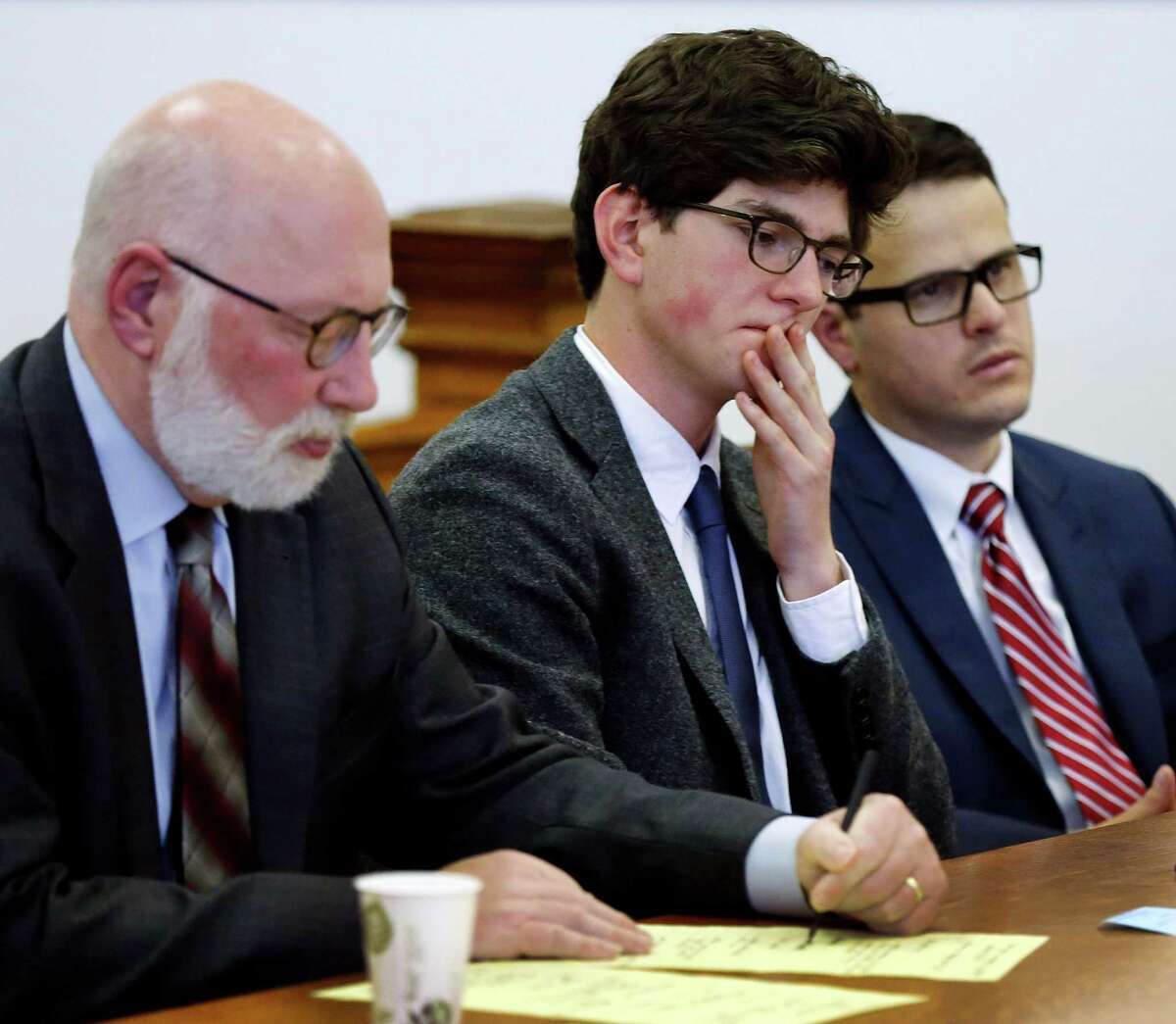 Owen Labrie, center, listens to a recorded statement from his victim with his lawyer J.W. Carney, left, and Sam Zaganjoir before being sentenced in Merrimack County Superior Court Thursday, Oct. 29, 2015, in Concord, N.H. The graduate of the exclusive St. Paul?’s School was sentenced to a year in jail for sexually assaulting a 15-year-old freshman girl as part of a tradition in which upperclassmen competed to rack up sexual conquests. Labrie was allowed to remain free on bail while he appeals his conviction. (AP Photo/Jim Cole, Pool)