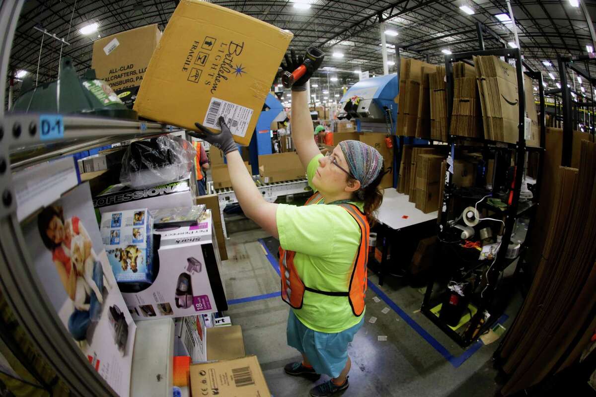 Ashley Merritt fills an order for shipping at the Amazon center during last year’s Cyber Monday. Cyber Monday is traditionally the busiest online shopping day of the year.
