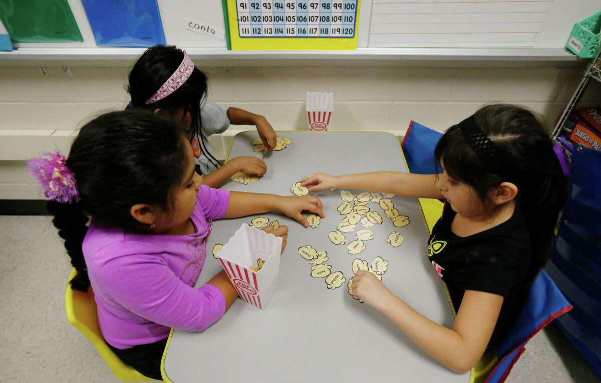 First-grade students in Mary Helen Romero's class attempt to recognize Spanish words written on tiles in their dual language class where a major portion of their lessons are taught in Spanish and the rest in English at Adams Elementary on Wednesday, Oct. 28, 2015. This approach has garnered Harland Independent School District recognition for their dual language strategies by the New American Foundation. Both English and Spanish-dominant language students are enrolled in Mrs. Romero's class. (Kin Man Hui/San Antonio Express-News)