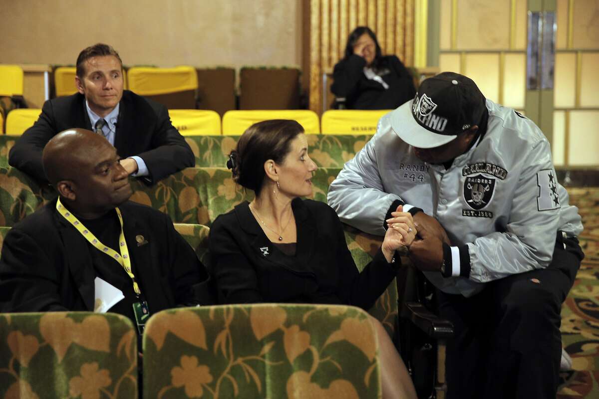 Oakland Raiders fan Randy Wright from Benicia speaks with Oakland Mayor Libby Schaaf as members of NFL Commissioner Roger Goodell's staff held a public hearing on the idea of the Raiders football team moving to southern California at the Paramount Theater in Oakland, Calif., on Thursday, October 29, 2015.