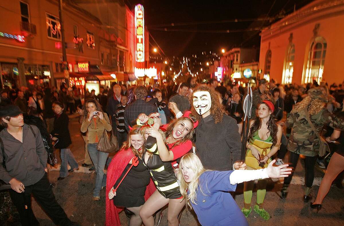 A group of party goers having fun on Castro St. Halloween in the Castro of San Francisco in 2006.
