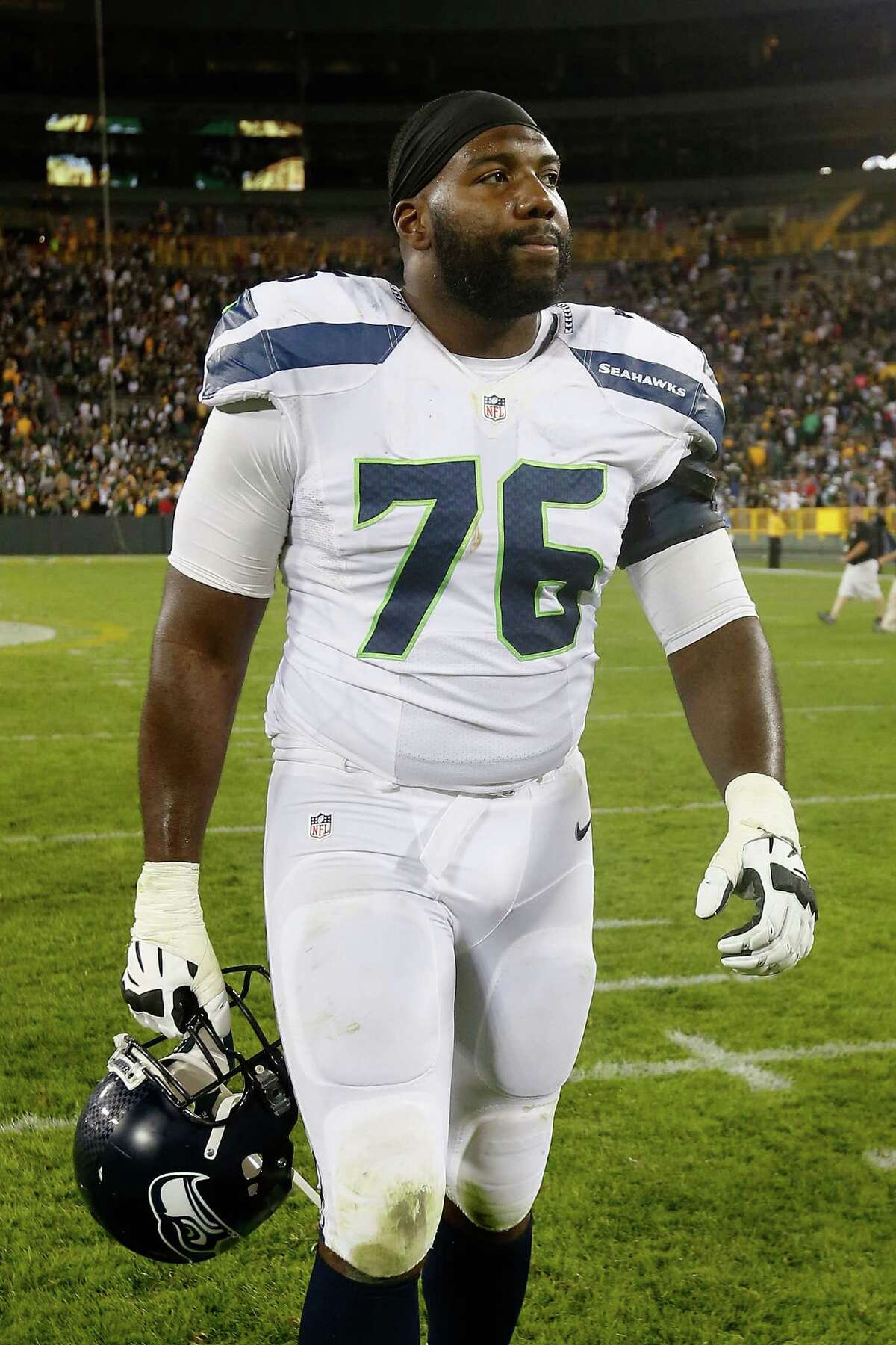 Tackle Russell Okung of the Seattle Seahawks walks off the field following the game against the Green Bay Packers at Lambeau Field on September 20, 2015 in Green Bay, Wisconsin.
