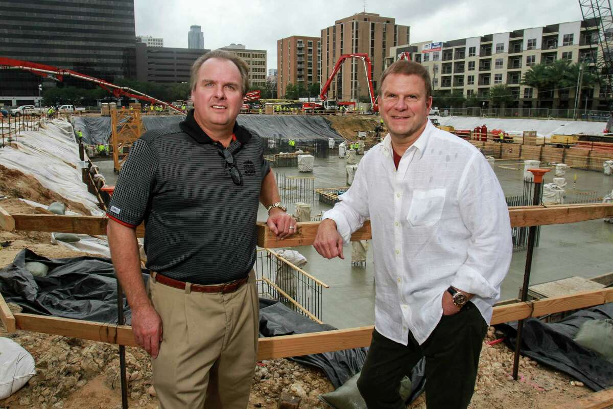 Landry's senior VP of development Jeff Cantwell, left, and CEO Tilman Fertitta during the concrete pour for The Post Oak, HoustonâÄôs first vertical mixed-use, master-planned project, a 35-story tower that combines hotel, office, residential, retail and restaurant offerings for the development. 700 trucks delivering approximately 6,000 cubic yards of concrete to the site continuously, with as many as 70 trucks on-site at the same time. Six concrete pump trucks and 200 workers pumping cement at a rate of 600 cubic yards per hour. Concrete pour encases 1,000 tons of rebar already in place in a 23-foot deep and 35,000 square foot hole.(For the Chronicle/Gary Fountain, October 30, 2015)