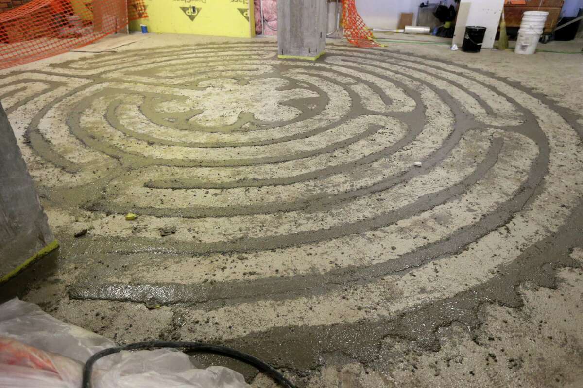 A labyrinth under construction in the main hall of The Bishop John E. Hines Center for Spirituality and Prayer. The labyrinth is based on the labyrinth at Chartres Cathedral in France.