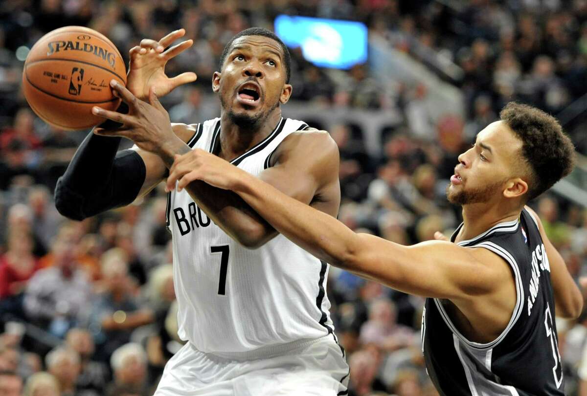 Brookly Nets forward Joe Johnson, left, is defended by San Antonio Spurs forward Kyle Anderson in the first half of an NBA basketball game Friday, Oct. 30, 2015, in San Antonio. (AP Photo/Bahram Mark Sobhani)