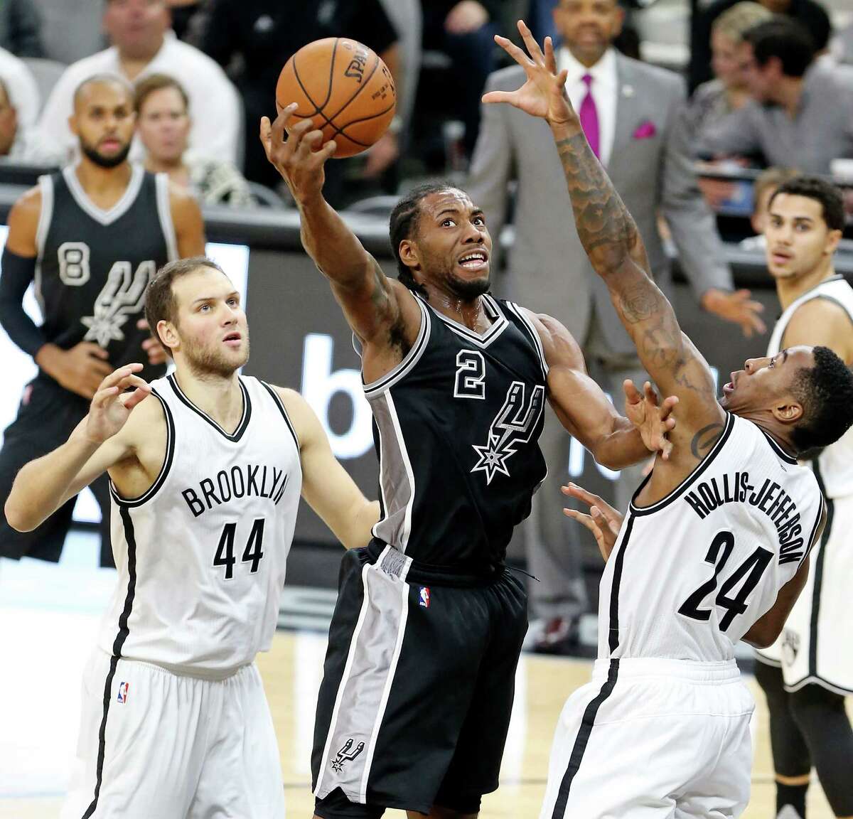 San Antonio Spurs' Kawhi Leonard grabs for control of the ball between Brooklyn Nets' Bojan Bogdanovic (left) and Rondae Hollis-Jefferson during second half action Friday Oct. 30, 2015 at the AT&T Center. The Spurs won 102-75.