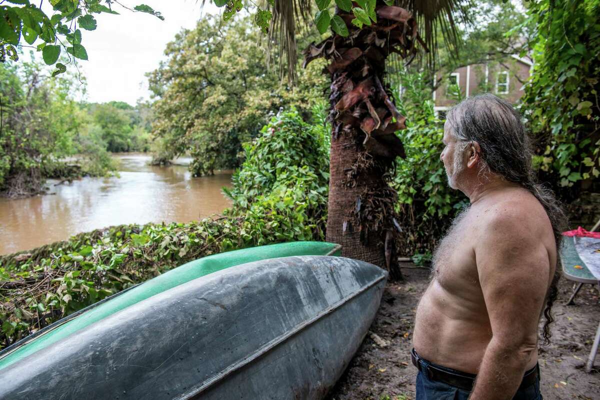 Brian Archer survey's the San Marcos river from his backyard after heavy rainfall caused flooding in his neighborhood in central Texas on Saturday, October 31, 2015. Archer refers to the area as "Hell's Half Acre," and said that the first thing he took from his home before the flooding was his vinyls and his family photographs.