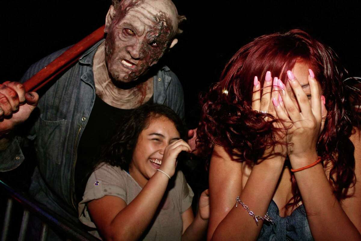 Costumed Halloween thrill seekers hit the 13th Floor Haunted House Saturday night, Oct. 31, 2015, for what has become a favorite spooky tradition — trick-or-treating to start off the night and then a good old fashioned scare at a haunted house.