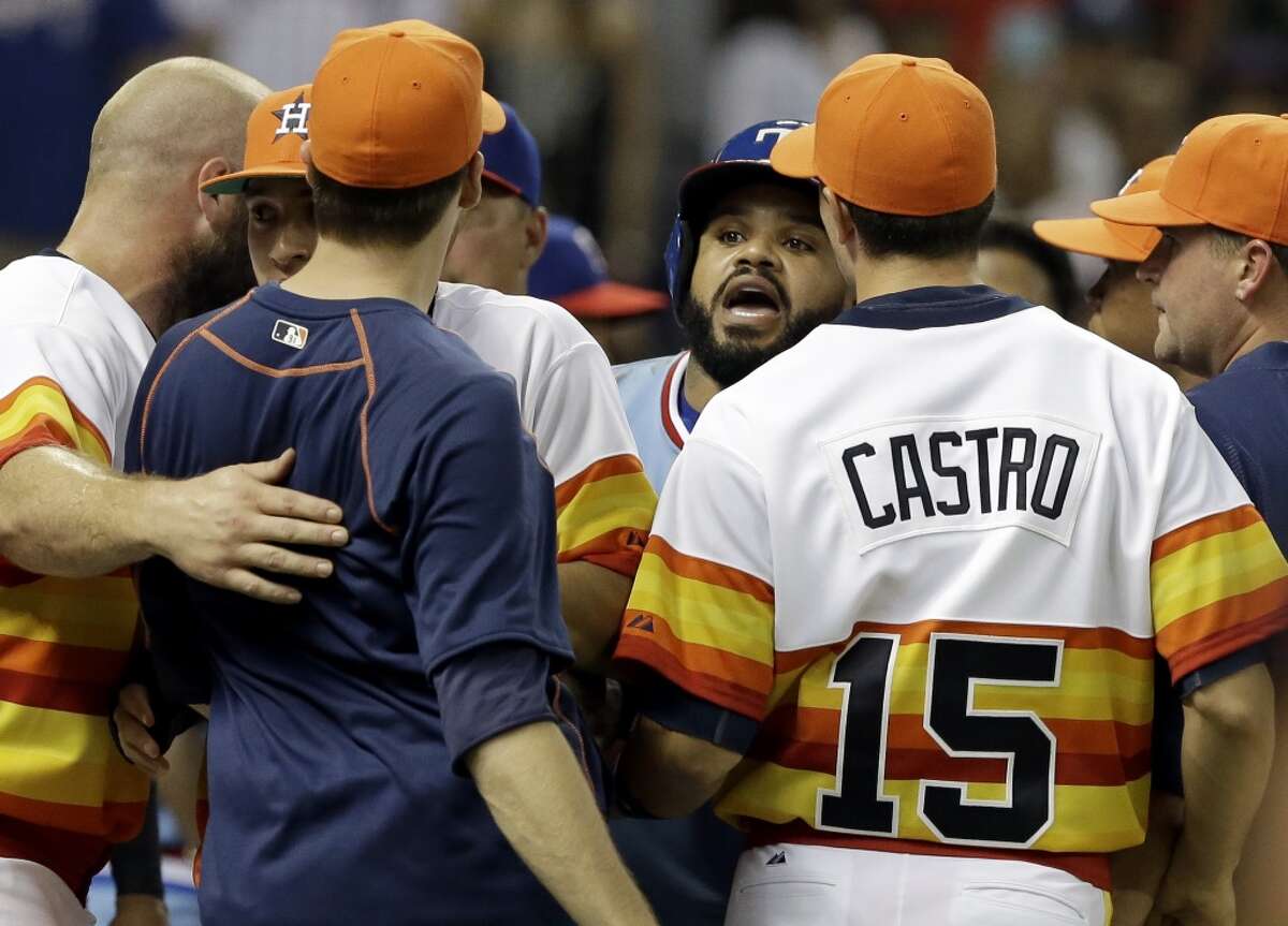 Texas Rangers' Prince Fielder, center, confronts Houston Astros' Jed Lowry, in navy blue, after both benches cleared in the ninth inning of a baseball game Saturday, July 18, 2015, in Houston. The confrontation took place after Astros catcher Hank Conger and Rangers' Rougned Odor exchanged words. (AP Photo/Pat Sullivan)