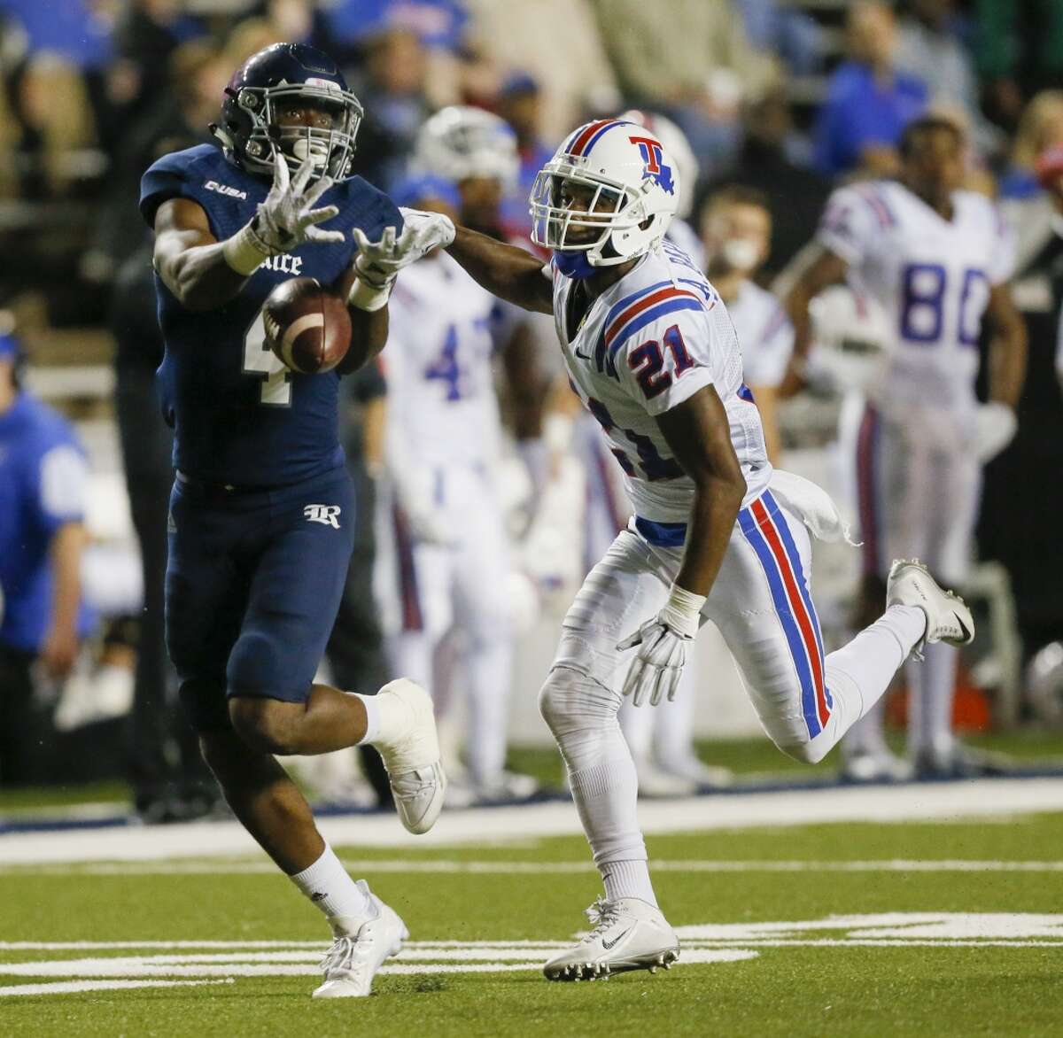 Rice Owls wide receiver Dennis Parks (4) has the ball go through his hands as he gets behind Louisiana Tech Bulldogs cornerback Adairius Barnes (21) during a NCAA Conference USA football game Friday, Oct. 30, 2015. (Bob Levey/For The Chronicle)