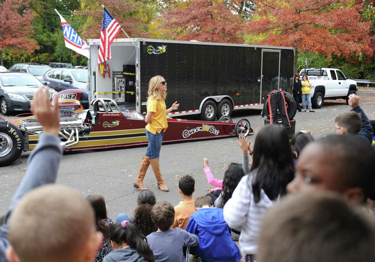 NHRA drag racer Sarah Edwards shows her top dragster vehicle to students at Julia A. Stark Elementary School. Edwards, a Stark School alumna and Stamford native, talked about her racing career and the science and aerodynamics of racing to a group of fourth-grade science students before letting the students get a close up look at her 1100 horsepower vehicle.