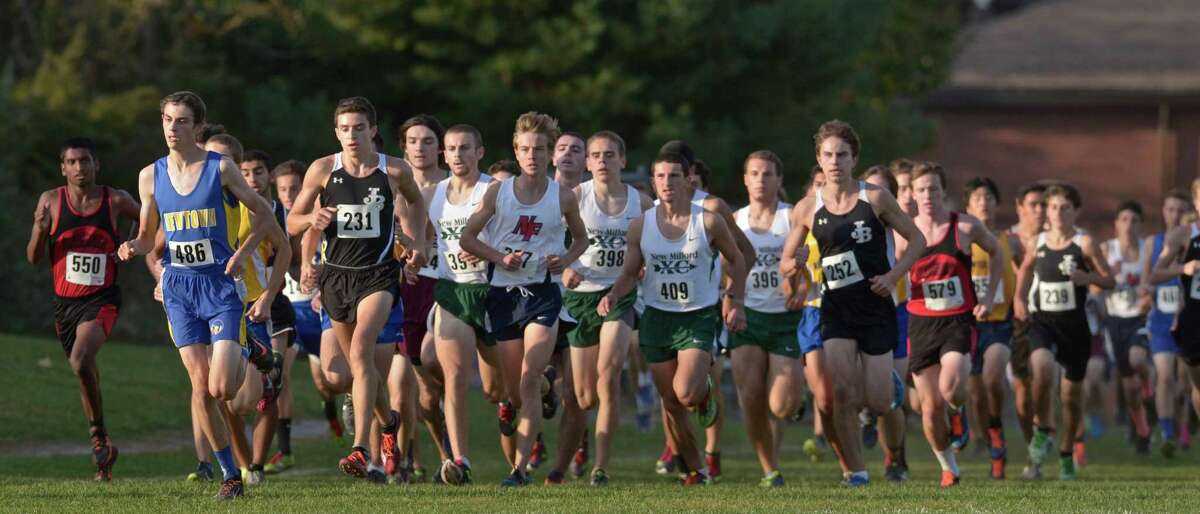 Runners cross a field during the boys SWC cross country championships, on Wednesday afternoon, October 21, 2015, held at Bethel High School, Bethel, Conn.
